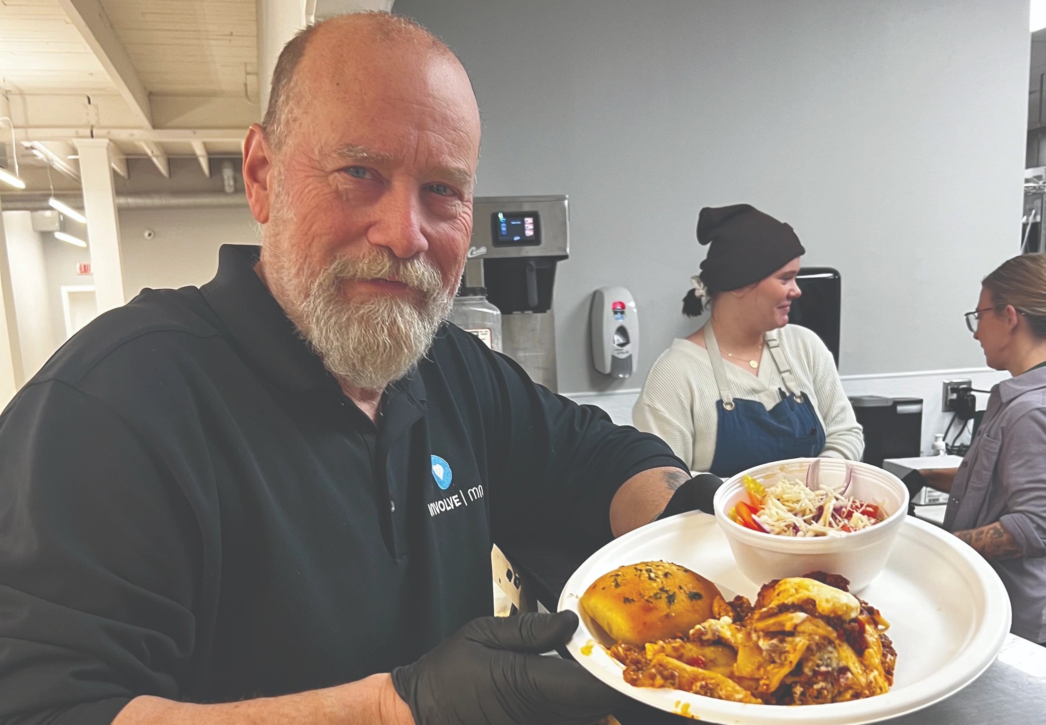 Grant Snyder serves lasagna with a garlic roll, salad and Christmas cookies for dessert.