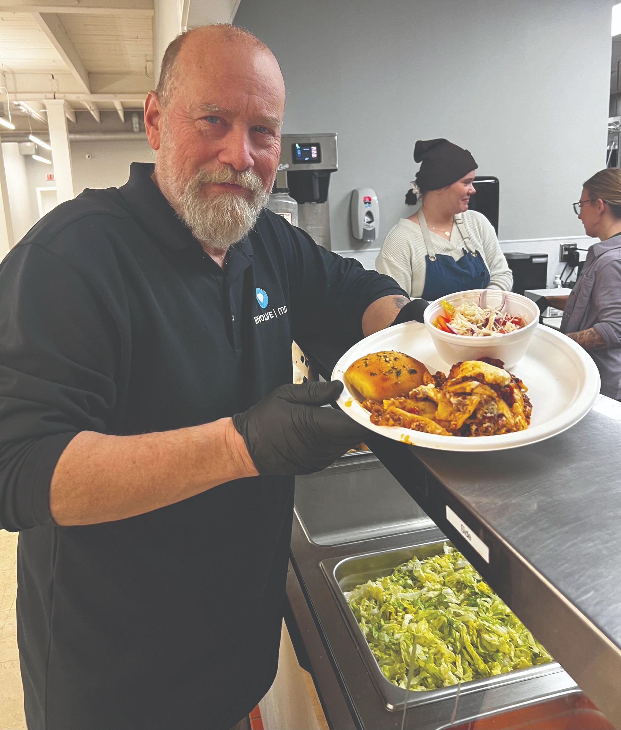 Grant Snyder serves lasagna with a garlic roll, salad and Christmas cookies for dessert.