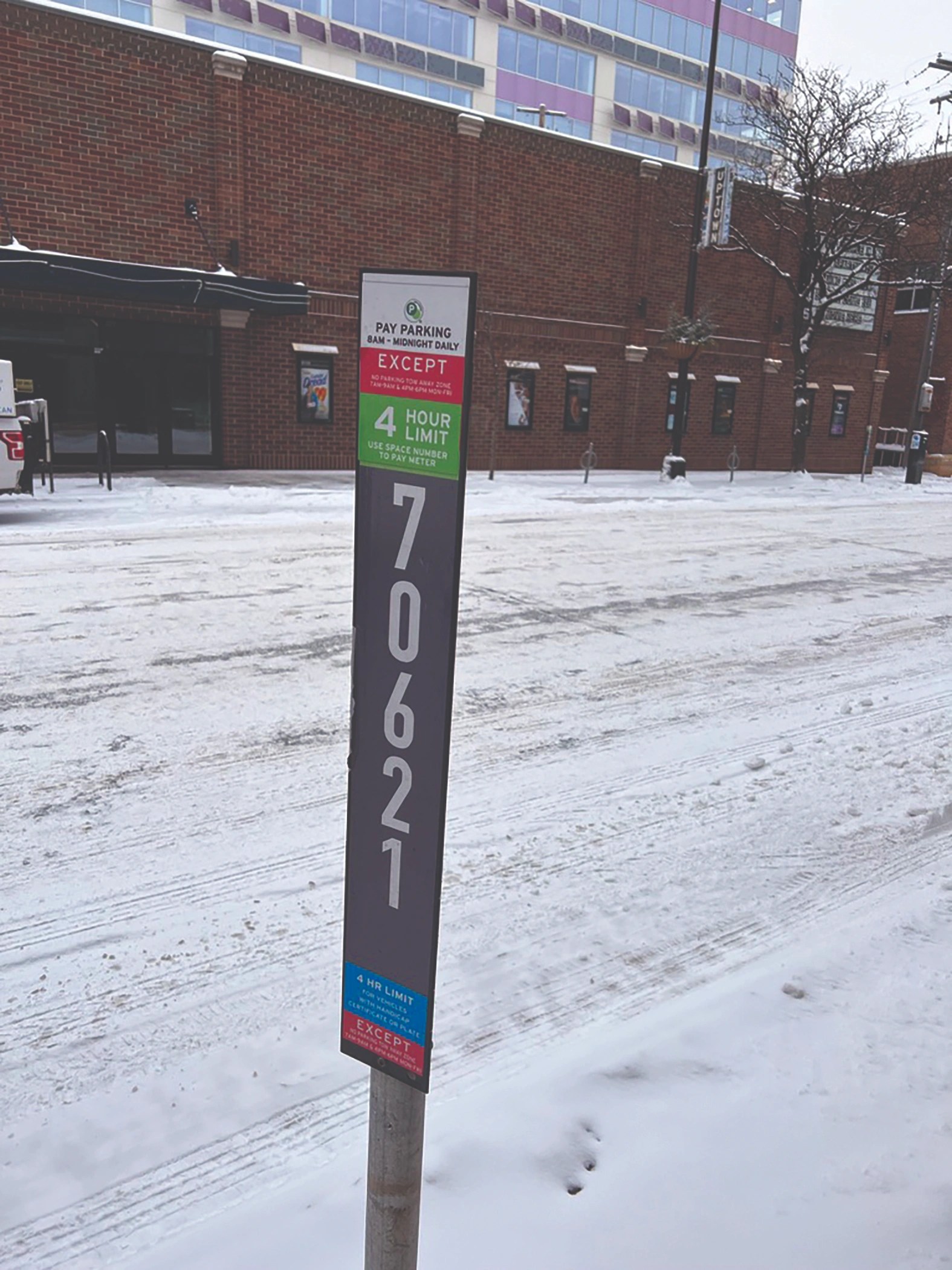 Lonely parking meters line a snowy Lagoon Avenue.