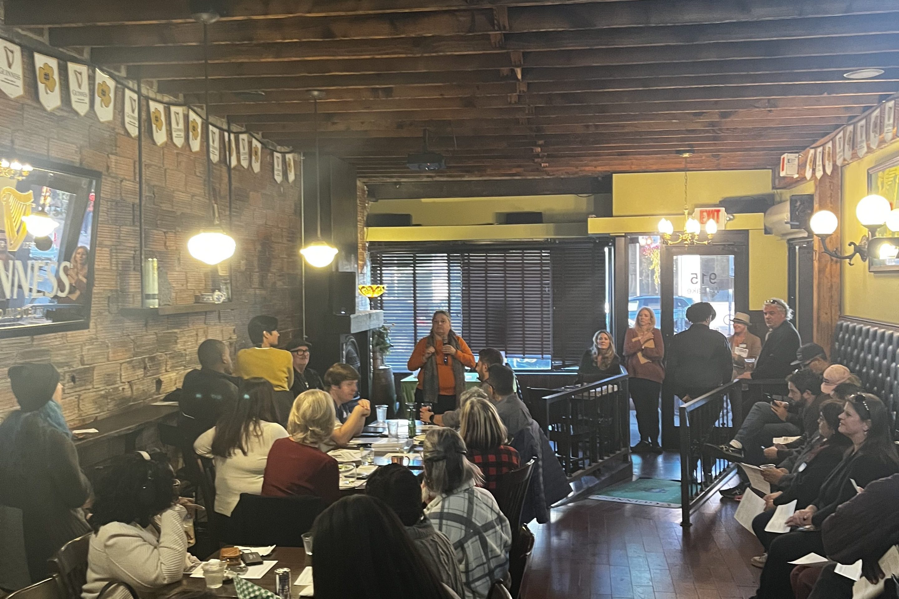 Carol Becker speaks to a crowded room