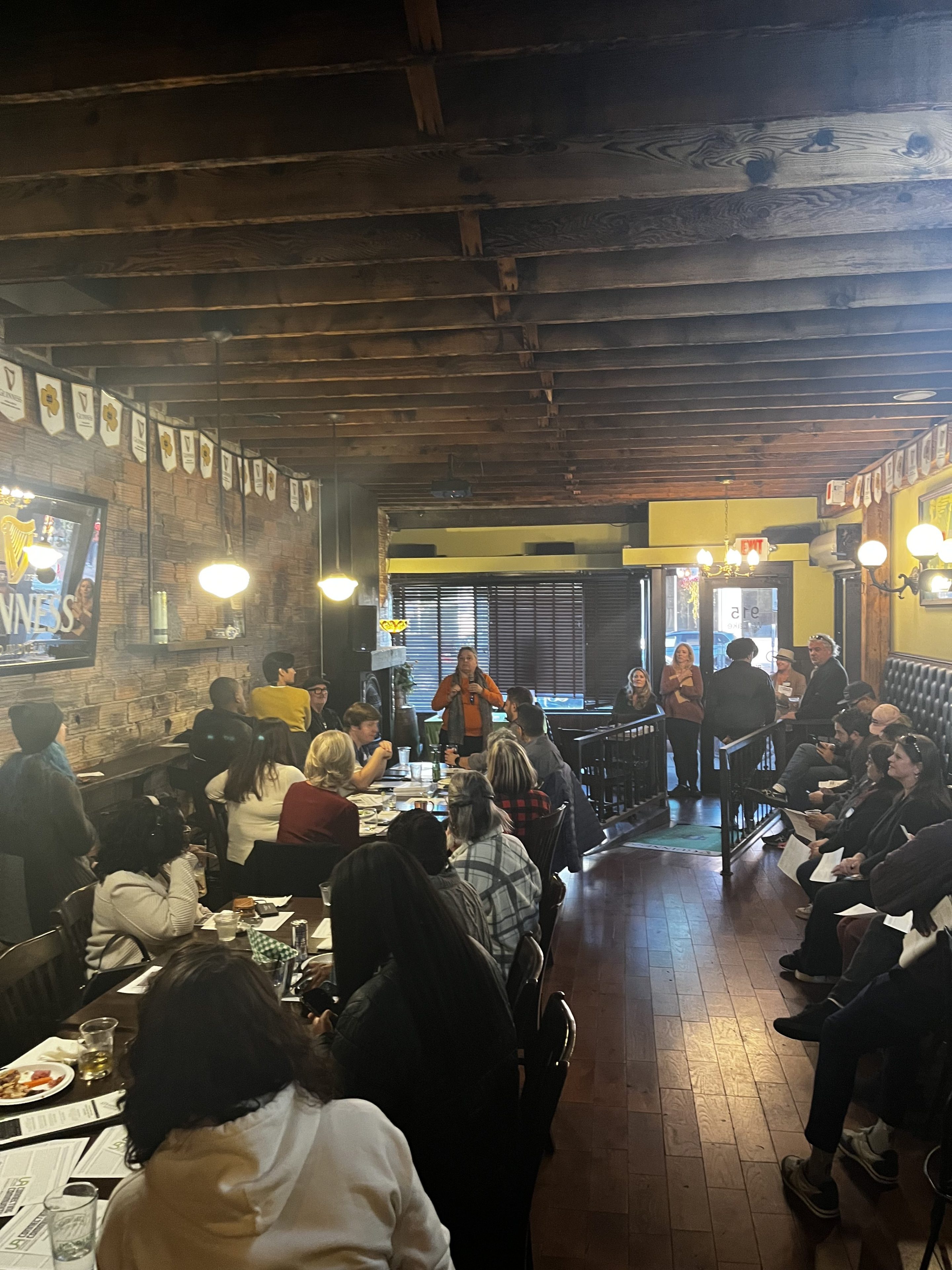 Carol Becker speaks to a crowded room