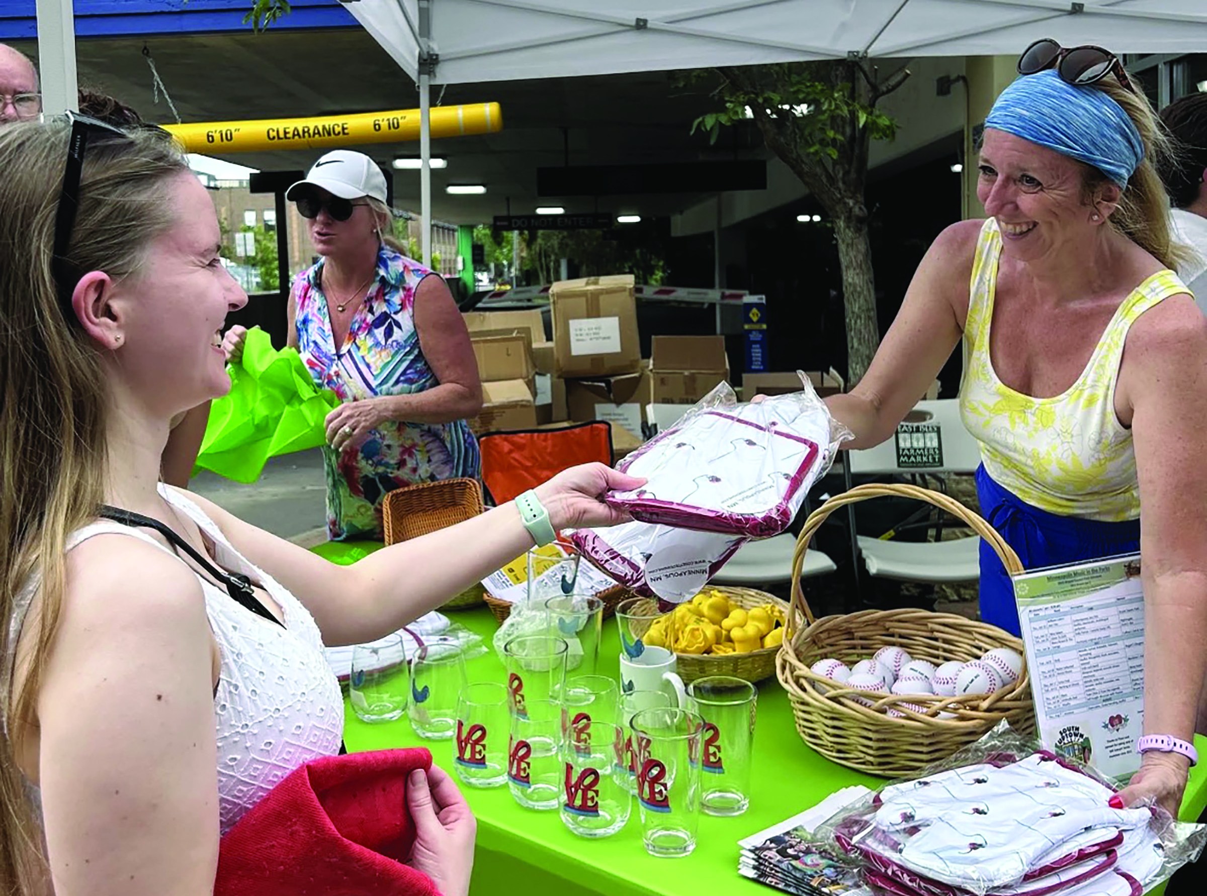 Woman making purchase at Uptown Farmers Market