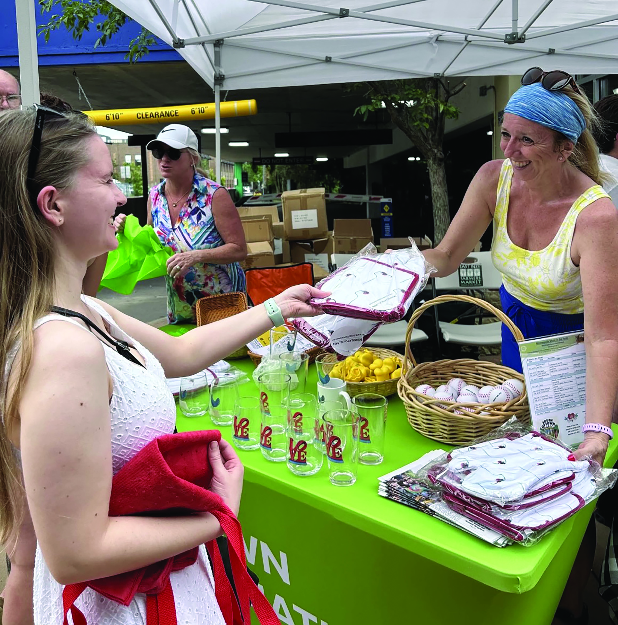 Woman making purchase at Uptown Farmers Market
